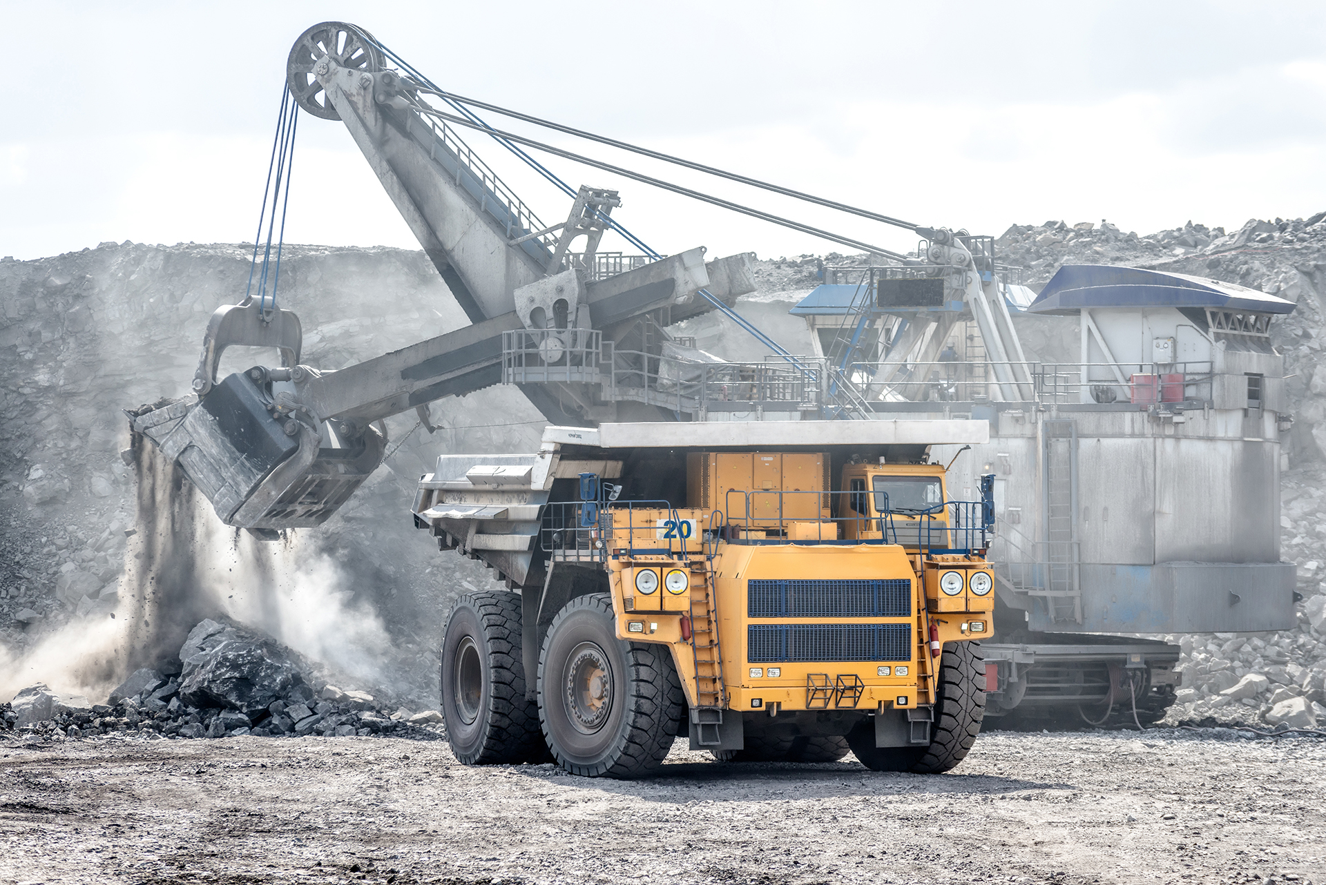 Ore loading with a powerful excavator. Loading a large mining truck.